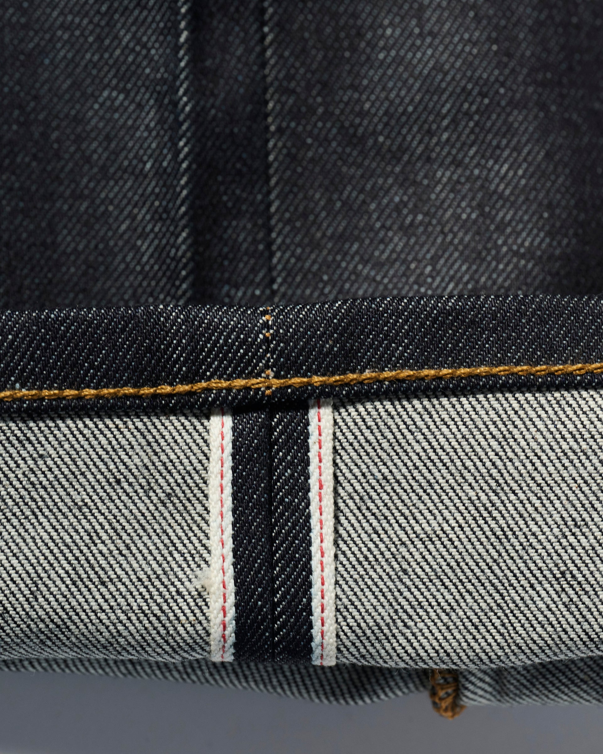 A close-up of The Cinch Jean in Yokohama Raw by T7C The Seven Continents, crafted from premium Japanese selvedge denim.
