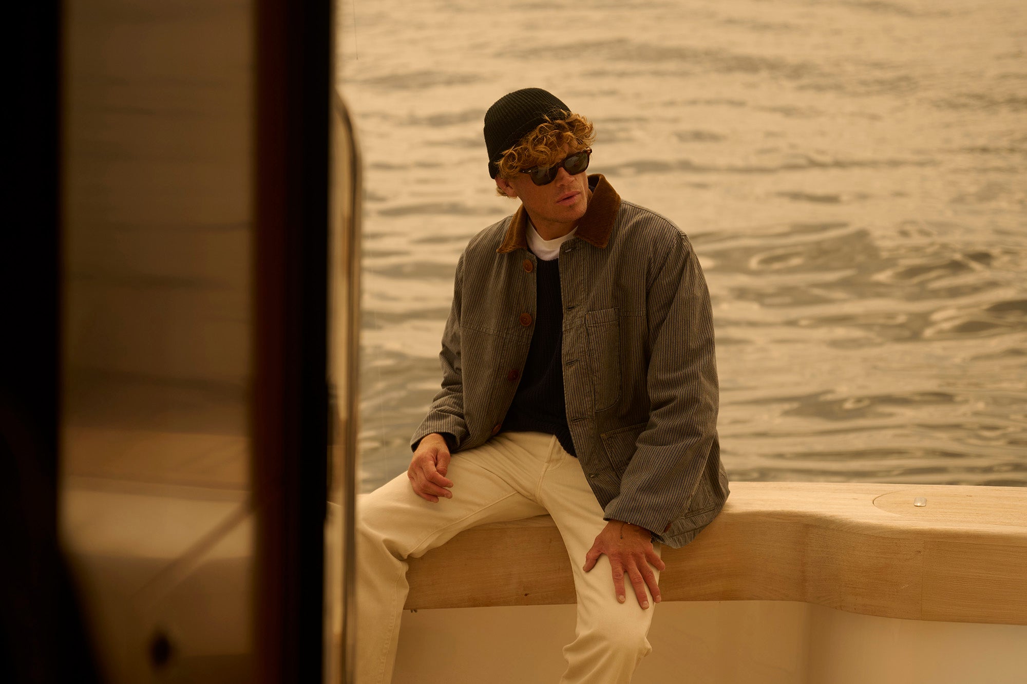 Man sitting on a boat with water in the background